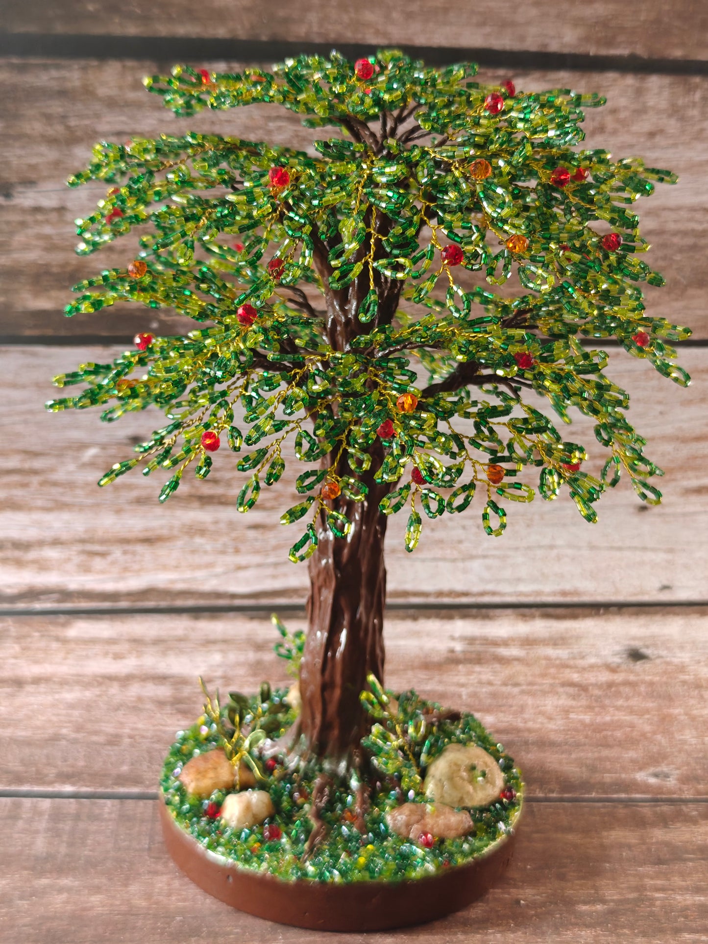 Green tree with red and orange fruits